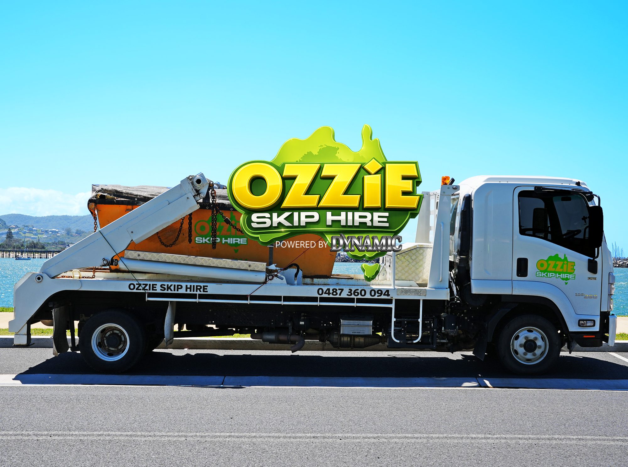 Ozzie Skip Hire truck loaded with a skip bin beside the water at Coffs Harbour